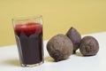 Glass of freshbeetroot smoothie on table, next to red beetroot herb Royalty Free Stock Photo