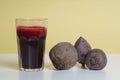 Glass of freshbeetroot smoothie on table, next to red beetroot herb Royalty Free Stock Photo