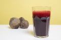 Glass of freshbeetroot smoothie on table, next to red beetroot herb Royalty Free Stock Photo