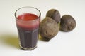 Glass of freshbeetroot smoothie on table, next to red beetroot herb Royalty Free Stock Photo