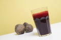 Glass of freshbeetroot smoothie on table, next to red beetroot herb Royalty Free Stock Photo