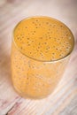 Glass of freshly pressed kiwi and peach juice on wooden table Royalty Free Stock Photo