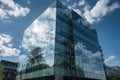 Glass fronted contemporary office building with a backdrop of a blue sky Royalty Free Stock Photo