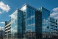 Glass fronted contemporary office building with a backdrop of a blue sky. Royalty Free Stock Photo