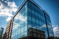 Glass fronted contemporary office building with a backdrop of a blue sky. Royalty Free Stock Photo