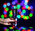 glass full of champagne against christmas lights. Holiday. Party Royalty Free Stock Photo