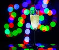 glass full of champagne against christmas lights. Holiday. Party Royalty Free Stock Photo