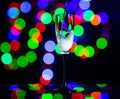 glass full of champagne against christmas lights. Holiday. Party Royalty Free Stock Photo