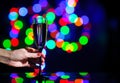 glass full of champagne against christmas lights. Holiday. Party Royalty Free Stock Photo