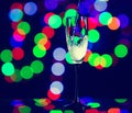 glass full of champagne against christmas lights. Holiday. Party Royalty Free Stock Photo