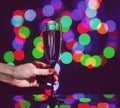 glass full of champagne against christmas lights. Holiday. Party Royalty Free Stock Photo