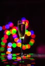 glass full of champagne against christmas lights. Holiday. Party Royalty Free Stock Photo