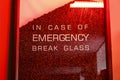 Glass full of coffee beans and the text. In case of emergency break glass