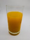 A glass full of energetic orange juice in a white background