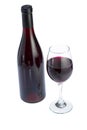Glass full of red wine and bottle. Royalty Free Stock Photo