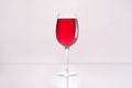 glass full of red wine on reflective surface Royalty Free Stock Photo