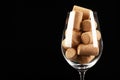 Glass full of wine corks on black background, closeup. Space for text Royalty Free Stock Photo