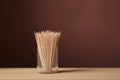 Wooden toothpicks in glass holder on table Royalty Free Stock Photo