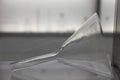 a glass funnel lies on a shelf in a chemical laboratory, pharmaceuticals