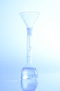 Glass funnel and volumetric flask Royalty Free Stock Photo