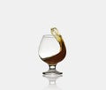 Glass glass with an alcoholic drink or cognac and splashes on a light background. Isolated, splash Royalty Free Stock Photo