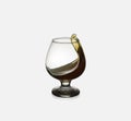 Glass glass with an alcoholic drink or cognac and splashes on a light background. Isolated, splash Royalty Free Stock Photo