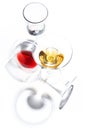 Glass glasses with drinks of different colors on a white background. Top view. The concept of an alcoholic cocktail Royalty Free Stock Photo