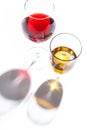 Glass glasses with drinks of different colors on a white background. Top view. The concept of an alcoholic cocktail Royalty Free Stock Photo