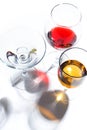 Glass glasses with drinks of different colors on a white background. Top view. The concept of an alcoholic cocktail Royalty Free Stock Photo