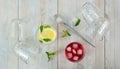 Glass glasses seen from above, some empty overturned others with iced red and yellow cocktails