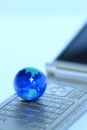 Glass globe over cellphone Royalty Free Stock Photo