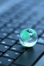 Glass globe over keyboard Royalty Free Stock Photo