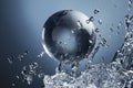 Glass globe planet in drop water splash on blue Royalty Free Stock Photo