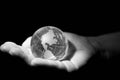 Glass globe, planet Earth, in the hands of a woman, black and white photo Royalty Free Stock Photo