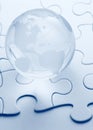 Glass globe with puzzle background Royalty Free Stock Photo