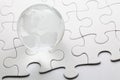 Glass globe with puzzle background Royalty Free Stock Photo