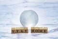 Glass globe and Stay Home logo block