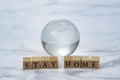 Glass globe and Stay Home logo block