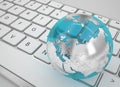 Glass globe on white keyboard Royalty Free Stock Photo