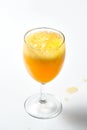 Glass goblet with bubbling orange liquid on a white background.