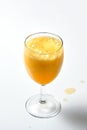 Glass goblet with bubbling orange liquid on a white background.