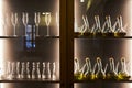 Glass goblets and bottles in a wooden cabinet