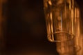 Glass goblets for wine, champagne, alcoholic drinks hang upside down above the bar. Warm orange evening light Royalty Free Stock Photo