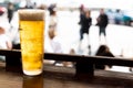 Glass of golden cold beer on counter facing street Royalty Free Stock Photo