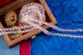 Glass and golden jewellery with sea shells in a wooden box. Jewellery and gift concept Royalty Free Stock Photo