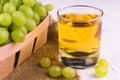 Glass with grape juice and a bunch of grapes on a white background. Royalty Free Stock Photo