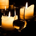 Glass of Grappa and candles Royalty Free Stock Photo