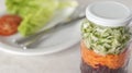 Glass with grated beetroot, carrot and cucumber and a plate on background Royalty Free Stock Photo