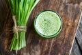A glass of green barley grass juice with fresh barley grass Royalty Free Stock Photo