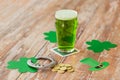 Glass of green beer, horseshoe and gold coins Royalty Free Stock Photo